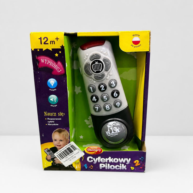 Cyferkowy Pilocik box front, grey and black toy remote control in an open window box