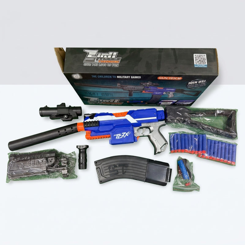 The gun unpacked beside its barrel, scope, foregrip, magazine and soft bullets