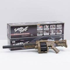The tan gun lying in its open box with the silencer, scope and darts beside it