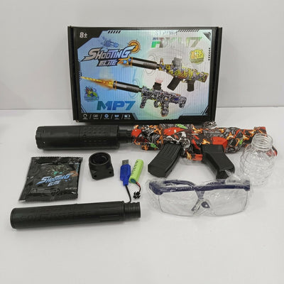 MP7-style water gel blaster beside its box, with magazine, barrel attachments, battery, USB cable, gel balls, soaking bottle and goggles laid out