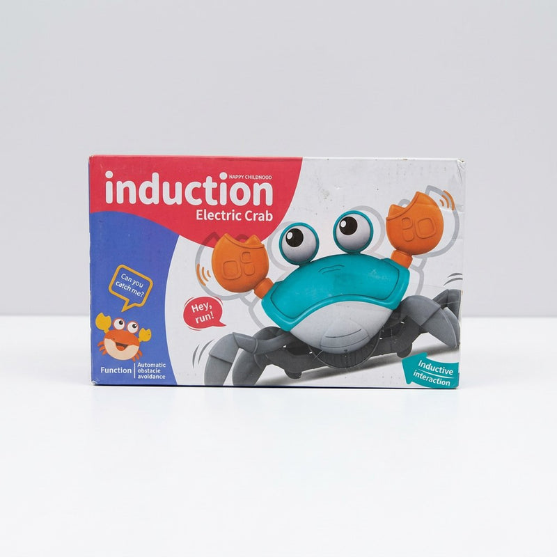 Electric crab toy box front, teal and white crab with orange pincer claws and an inductive-interaction badge