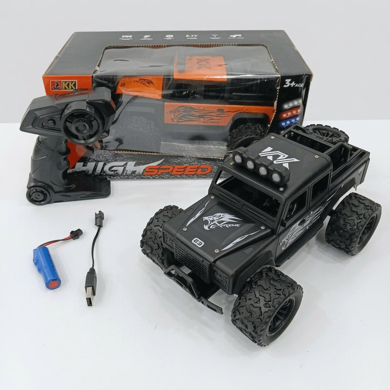HIGH SPEED monster truck box front with the 3+ age mark and feature icons, and the black off-road truck, remote control, battery and USB cable laid out in front