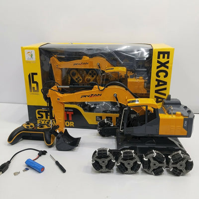 Stunt RC excavator on its omni-directional wheels, with its digging arm and bucket, remote control, battery pack and screwdriver