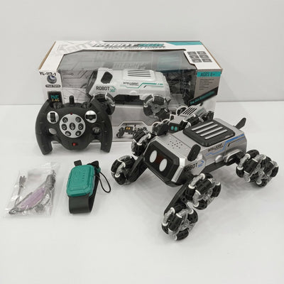 White and grey "ROBOT" RC stunt car with roller wheels, its two-stick remote and gesture-control wristband, beside the "AGES 8+" box