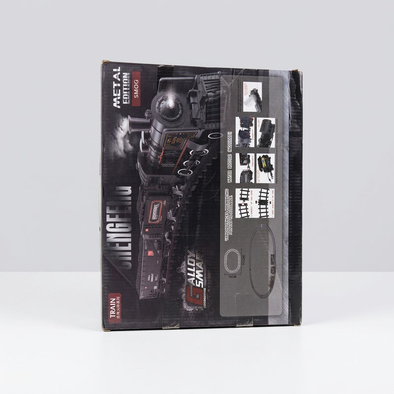 Close-up of the box front showing the locomotive's wheels and boiler detail, the feature icon row and the shop price sticker