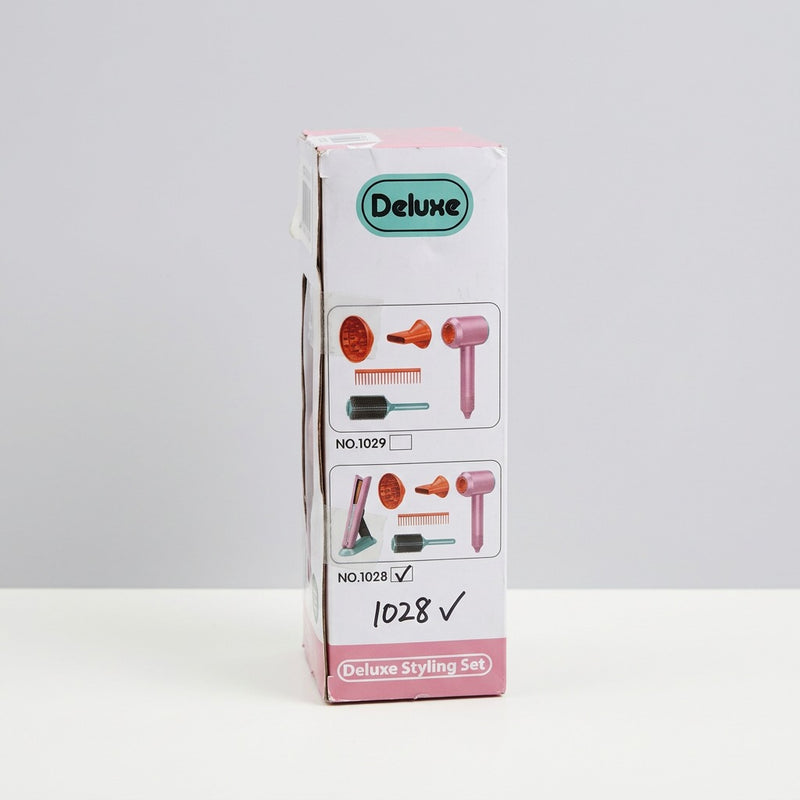 Reverse of the box with the shop price sticker and a child using the hairdryer