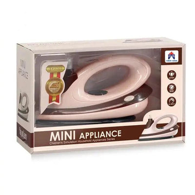 Front of the Mini Appliance Toy Iron package, showing the pink and brown iron through a clear window with a "3+ AGES" badge and feature icons for battery, visual and DIY play