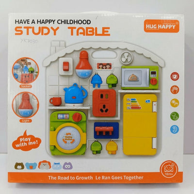 Busy Board Study Table box front, house-shaped sensory panel with socket, light, washing machine and fridge, 18m+ badge