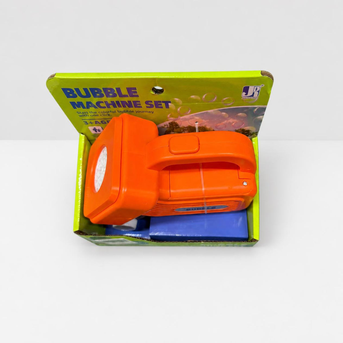 Orange bubble machine sitting in its open display box