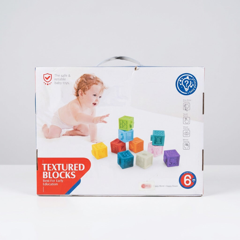 Box back panel with a baby reaching for a stack of the blocks