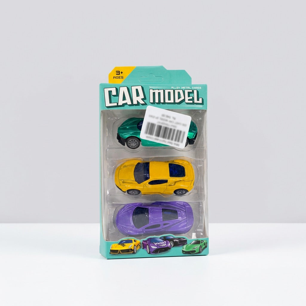 The pack held in a hand, showing the purple, yellow and green cars