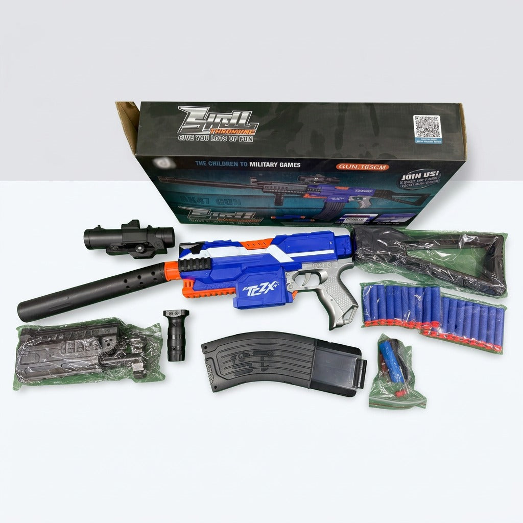 The gun unpacked beside its barrel, scope, foregrip, magazine and soft bullets