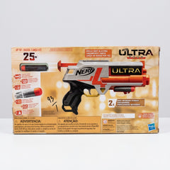 The blaster laid flat, showing the orange handle, black grip and dart clips