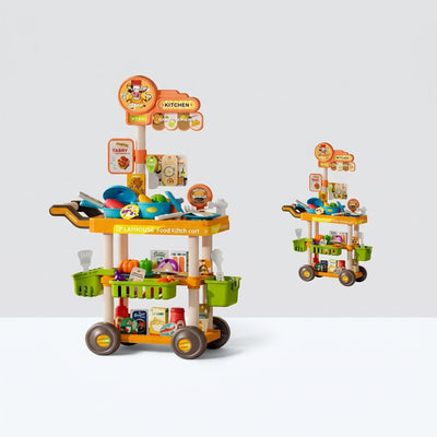 Two-tier wheeled tableware cart with play pots, pans and bowls on top and baskets of play food below, next to its Playhouse Tableware Cart box showing the 69PCS badge