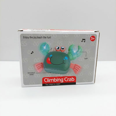 Climbing crab toy box front, green crab with pink claws, light and music-note icons, and a 3+ age badge