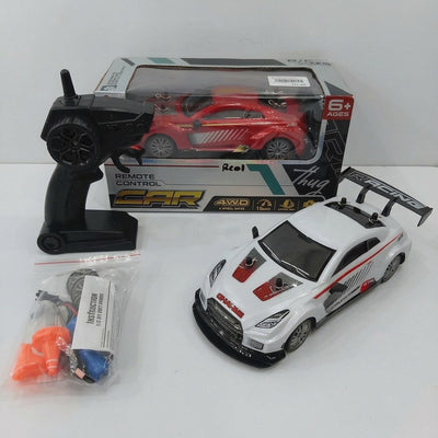 Remote Control Car Racing box front with the 6+ age mark and 4WD / 15 km/h feature icons, and the white GTR-badged car, remote control, spare wheel, cone and battery pack laid out in front