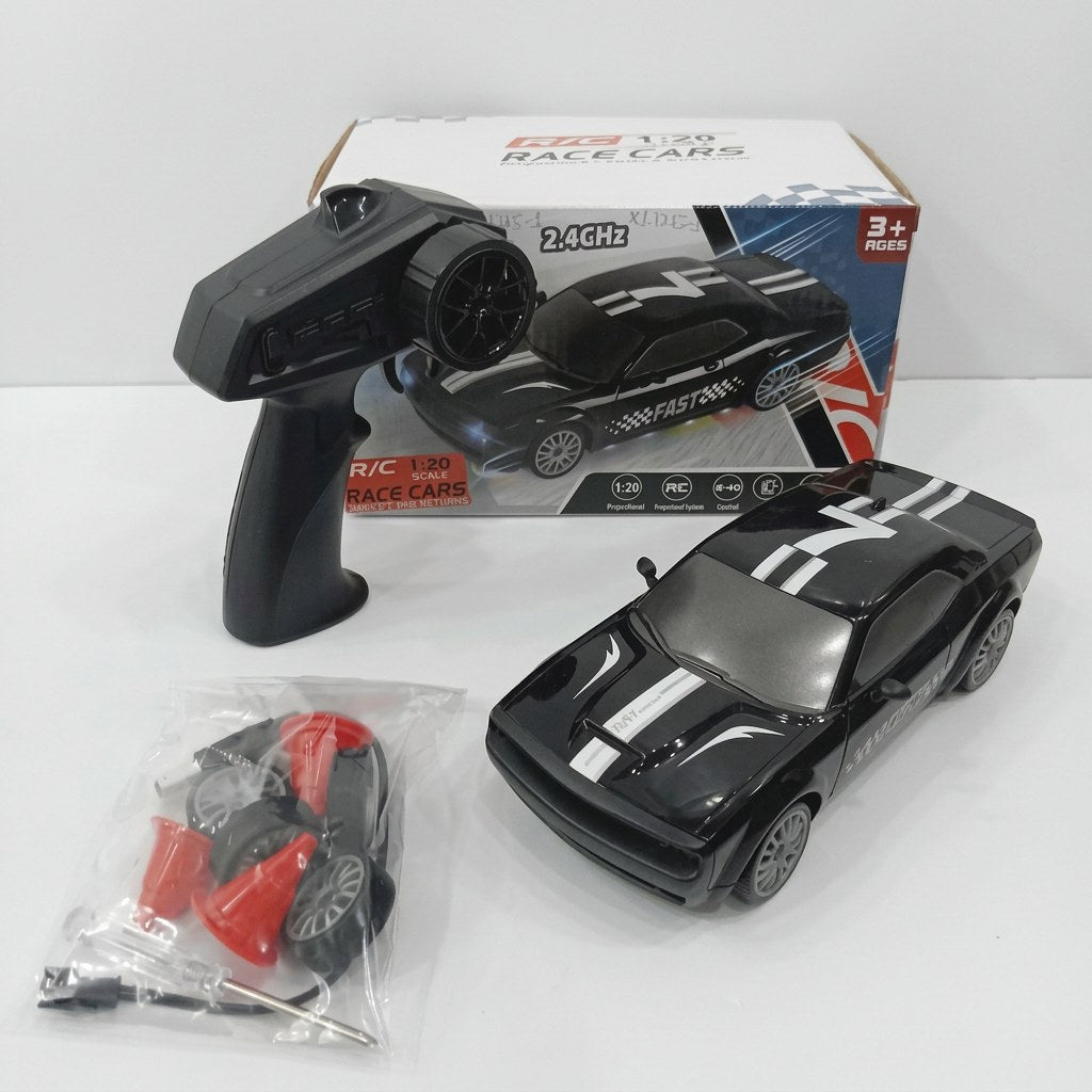 Black 1:20 RC rally race car numbered 7, with its pistol-grip controller, spare wheel, traffic cones and screwdriver, beside the "3+ AGES" box