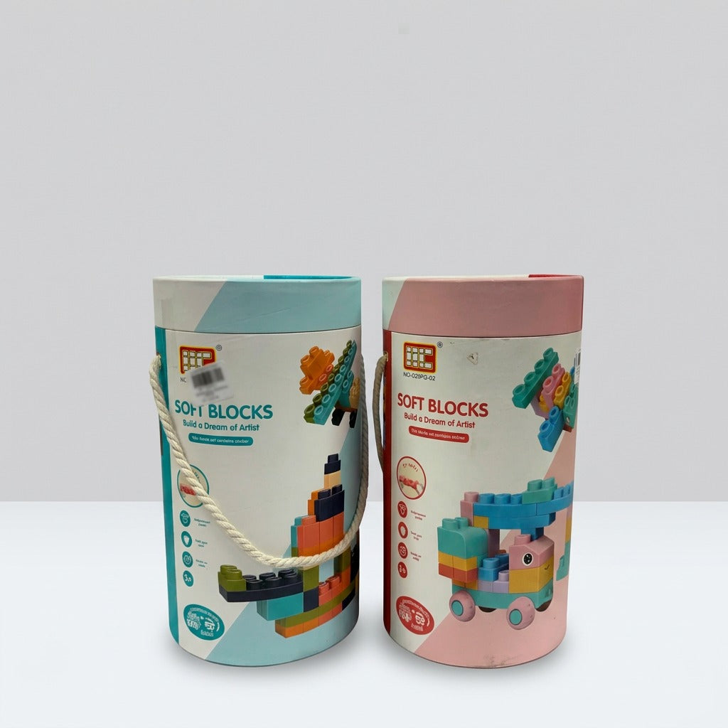 Two Soft Blocks carry tubes side by side, one pink-topped and one teal-topped, each with a woven rope carry handle