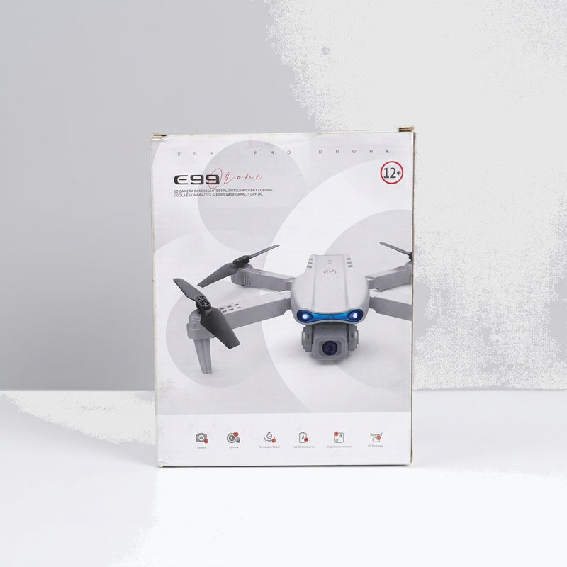 Close-up of the shop price sticker reading Drone With Cmera (U1) Rs. 10,875.00, next to the red remote control