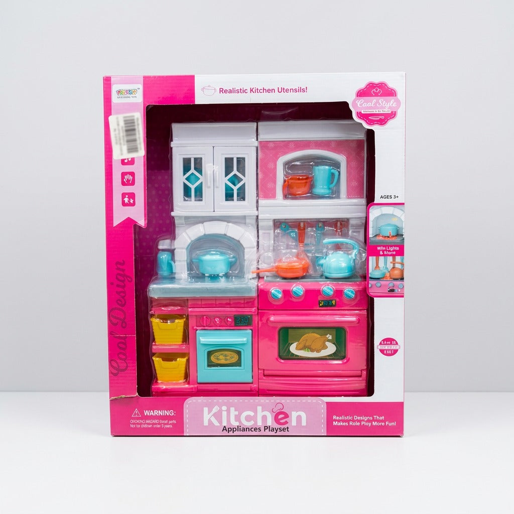 Box front, pink stove-and-oven and sink unit with the kettle, teapot and 2 mugs