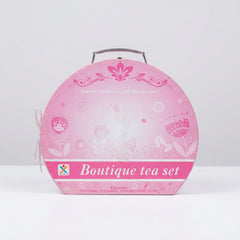 Close-up of the floral tin print on the saucers and teapot, with the shop price sticker