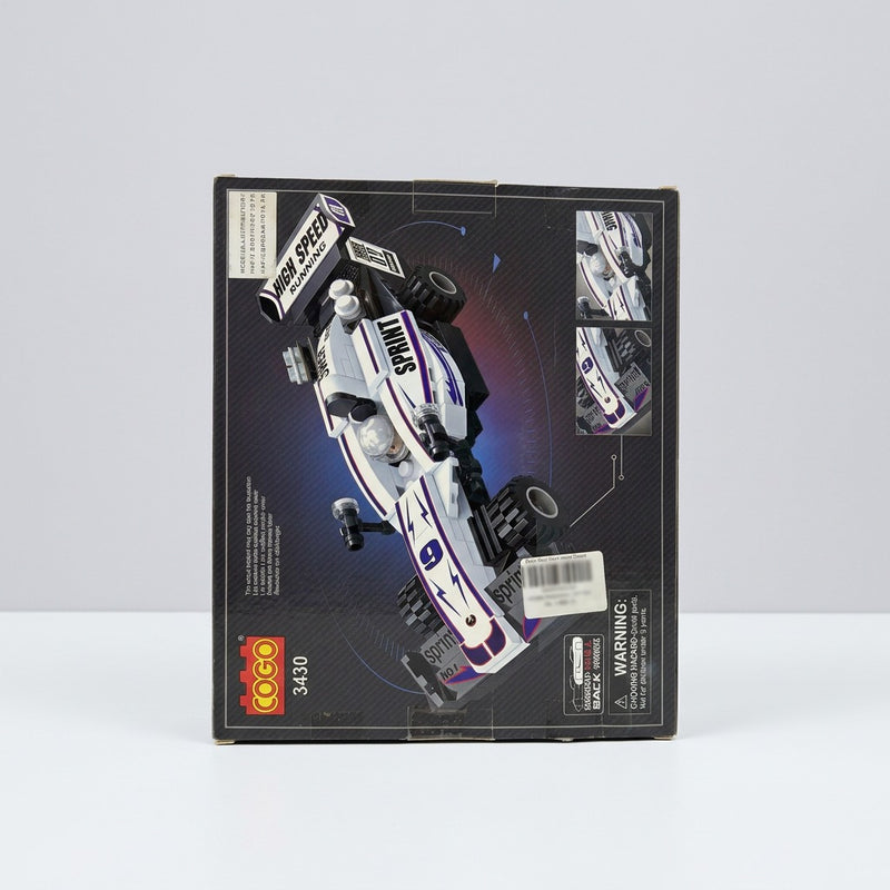 White and purple building-block race car box, back panel showing the same model and the choking-hazard warning